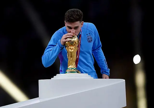 Argentina forward Julian Alvarez kisses the World Cup trophy