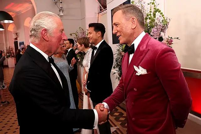 The then prince of Wales meets Daniel Craig upon his arrival for the World Ki Premiere of No Time To Die (Chris Jackson/PA)