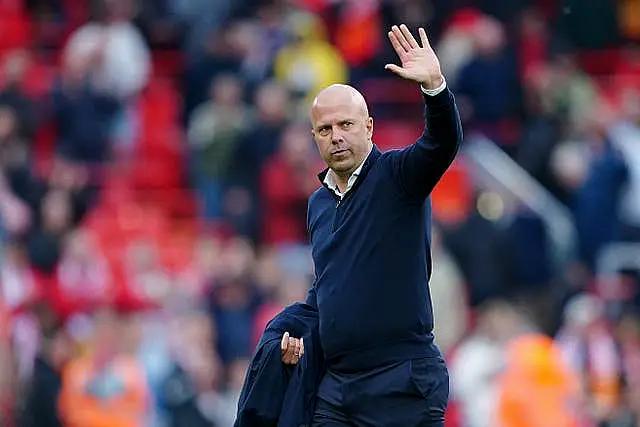 Arne Slot waves to the Liverpool crowd after the win over Brentford