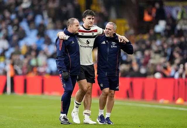 Harry Maguire is helped off the pitch