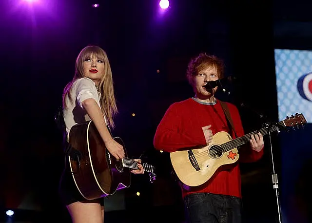 Taylor Swift and Ed Sheeran on stage holding guitars