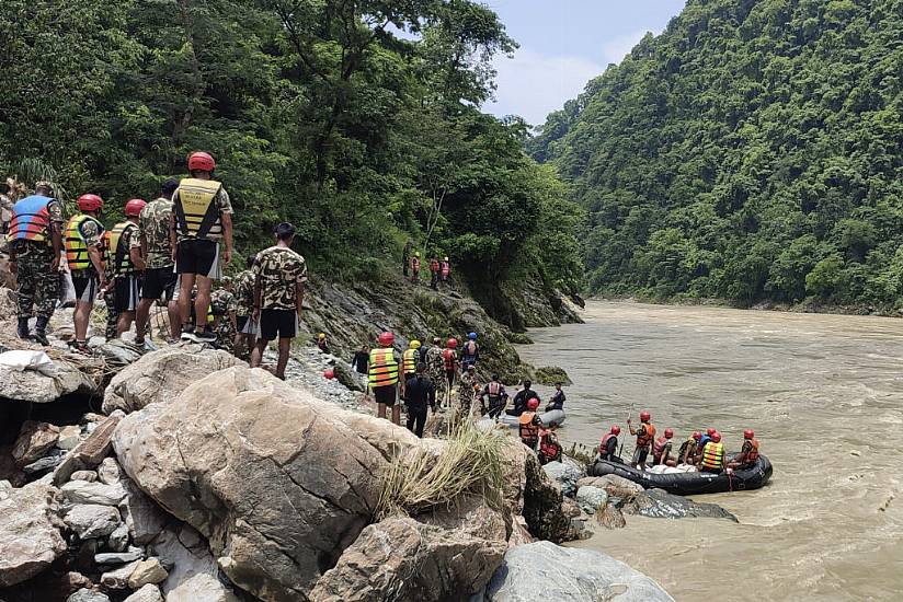 Rescuers Recover First Body After Buses Swept Into River In Nepal