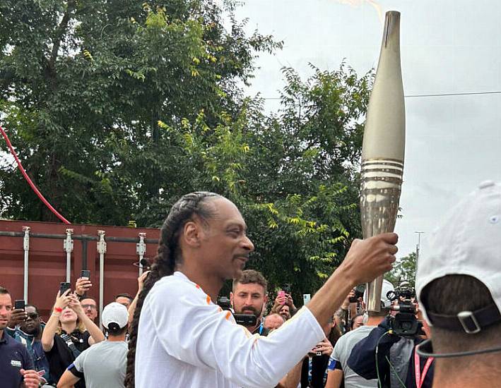 Crowds Cheer As Snoop Dogg Carries Olympic Torch For Paris 2024 Games