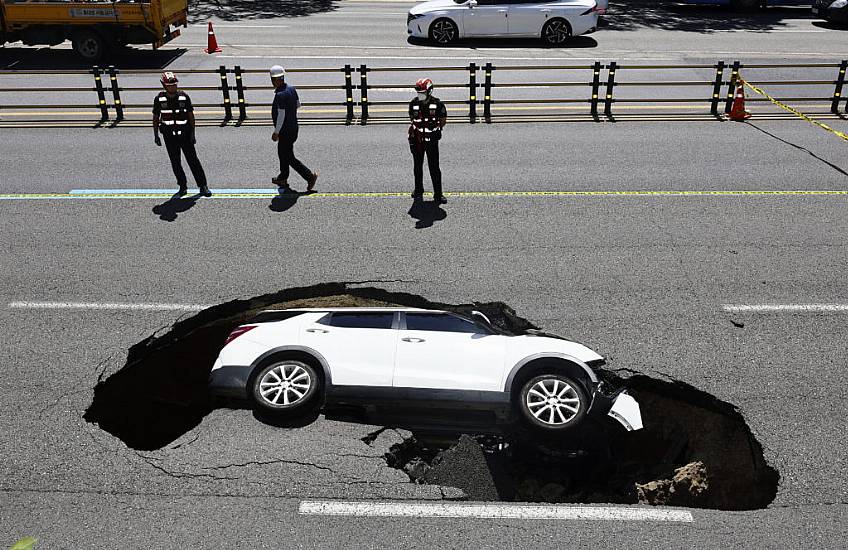 Driver And Passenger Injured As Car Is Swallowed Up By Sinkhole