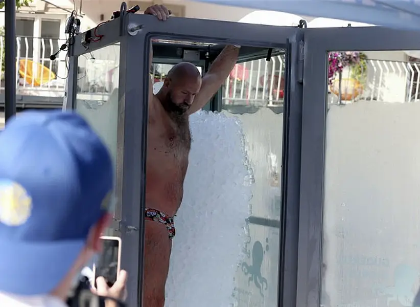 Josef Koeberl leaves a glass cabin filled with ice, after he set a new record (Ronald Zak/AP)