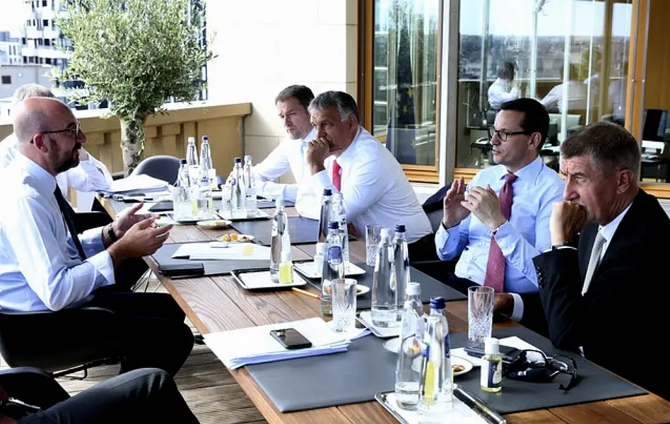 From left, European Council President Charles Michel, Slovakia’s Prime Minister Igor Matovic, Hungary’s Prime Minister Viktor Orban, Poland’s Prime Minister Mateusz Morawiecki and Czech Republic’s Prime Minister Andrej Babis meet on the sidelines of the EU summit (Francois Walschaerts, Pool/AP)