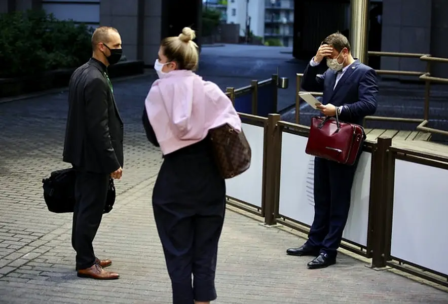 Luxembourg’s Prime Minister Xavier Bettel (rights) waits for his car after talks broke up before dawn (Olivier Matthys, Pool/AP)